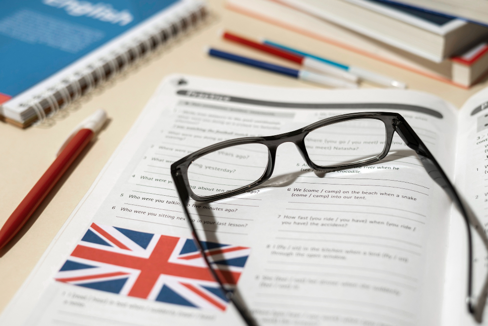 english book with glasses table